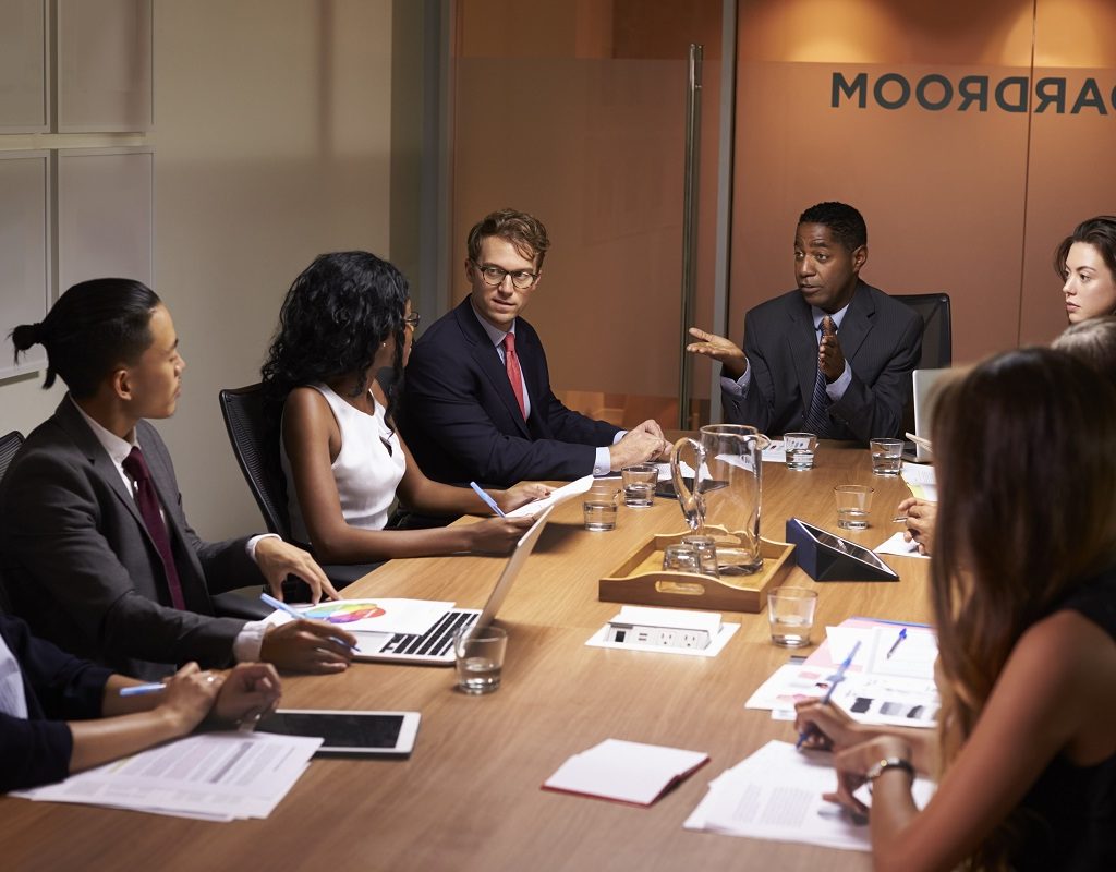 Businessman addressing corporate colleagues at a meeting